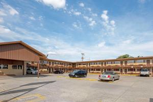 a parking lot in front of a large building at Rodeway Inn Terre Haute in Terre Haute