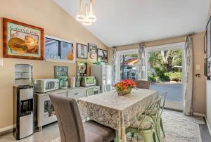 a kitchen with a table and chairs and a kitchen with a window at The Malibu Retreat Guest House - Salt Water Pool & Jacuzzi, Nature Oasis in Calabasas +9 photos