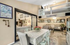 a dining room with a table and chairs and a couch at The Malibu Retreat Guest House - Salt Water Pool & Jacuzzi, Nature Oasis in Calabasas