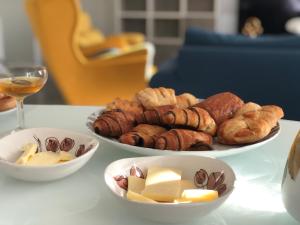a table with two bowls of pastries and a plate of food at Welcome Milano Guest House in Milan