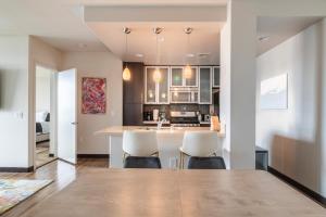 a kitchen with a table and chairs in a room at Brand New 2BR WeHo Luxury Apartment in Los Angeles