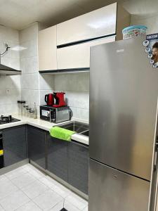 a kitchen with a stainless steel refrigerator at SYN - Mpila in Brazzaville