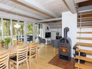 a living room with a fireplace and a table and chairs at 8 person holiday home in Fur in Fur