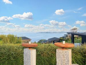 a view of the ocean from a house with two mushrooms at 8 person holiday home in L gstrup in Løgstrup