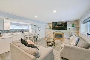 a large living room with two couches and a fireplace at New York Abode with Pool and Patio, Near Times Square! in Islip Terrace