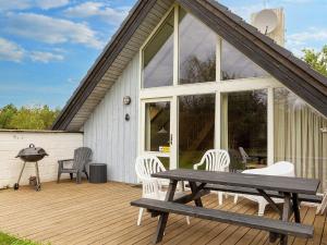 um deque de madeira com uma mesa de piquenique e cadeiras em 8 person holiday home in Fur em Fur