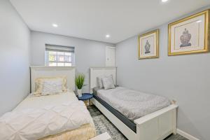 a bedroom with two beds and a window at New York Abode with Pool and Patio, Near Times Square! in Islip Terrace