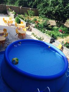a large blue bath tub with tables and chairs at Zanger Hotel in Goris