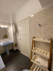 a bathroom with a sink and a toilet and a mirror at Hotel California in Mar del Plata