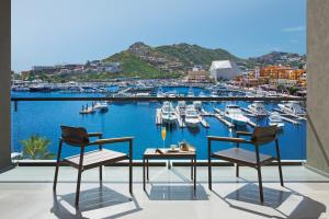 a balcony with a view of a marina with boats at Breathless Cabo San Lucas - Adults Only in Cabo San Lucas