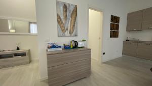 a kitchen with wooden floors and a counter top at Casa Princi - lago Ceresio in Porto Ceresio