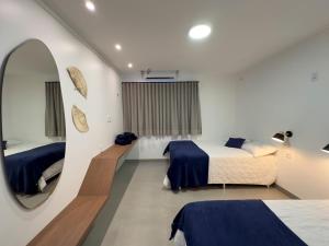 a bedroom with two beds and a mirror at Alter do Chão - Alter Casa Cocar in Alter do Chao +15 photos