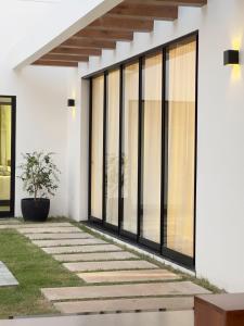 a facade of a house with large windows at Alter do Chão - Alter Casa Cocar in Alter do Chao