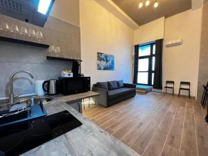 a kitchen and a living room with a couch at Grandera Apart's - Cervero 24A in Valencia