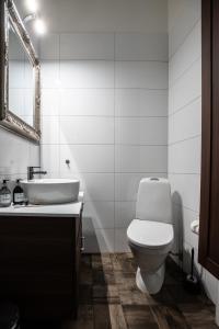 y baño con aseo blanco y lavamanos. en Spacious Oasis only Minutes From the City Center, en Estocolmo