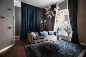 a living room with a couch and a table at Spacious Oasis only Minutes From the City Center in Stockholm