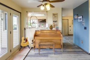 a living room with a piano and a guitar at Airy Vernal Vacation Rental Deck, Mountain Views! in Vernal