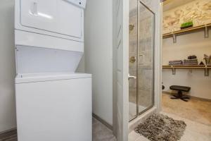 a bathroom with a walk in shower next to a glass door at Best 5* Luxury Living Downtown kingbed Suite in Houston