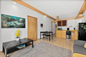 a living room with a table and a kitchen at Cozy Queen Suite in European Village with Balcony view near beaches in Palm Coast
