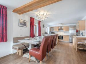 a kitchen and dining room with a table and chairs at Kitzbüheler Alpen XL in Bramberg am Wildkogel