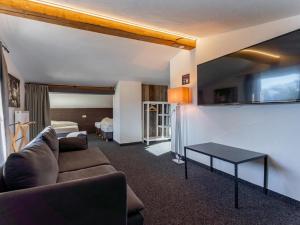 a living room with a couch and a table at Chalet H Königsleiten in Königsleiten