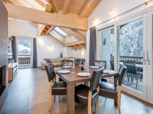 a dining room and living room with a table and chairs at Saalbach Hinterglemm in Saalbach Hinterglemm