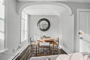 a dining room with a table and chairs and a mirror at Midtown 1BR: Downtown HBG Hub in Harrisburg