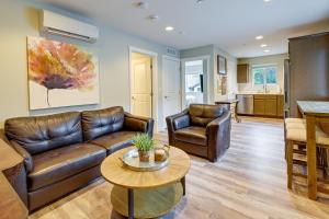 a living room with a couch and a table at Modern SeaTac Gem with Fireplace and Smart TVs! in SeaTac