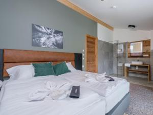a bedroom with a bed with white sheets at Aquarius Haus 9 TOP 18 in Sankt Lorenzen ob Murau