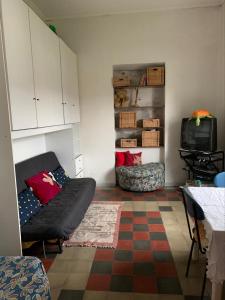 a living room with a couch and a tv at Rovaio in Fivizzano