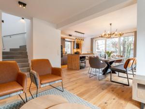 a kitchen and living room with a table and chairs at Mountain Chalet Dahoam in Sankt Lorenzen ob Murau