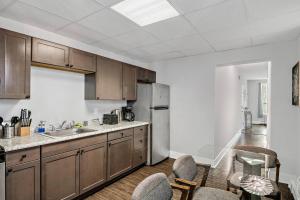 a kitchen with wooden cabinets and a stainless steel refrigerator at HBG 1BR: Modern Vintage Gem in Harrisburg
