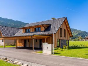 a house with a gambrel roof on a road at Mountain Chalet Aquarius 5B in Sankt Lorenzen ob Murau