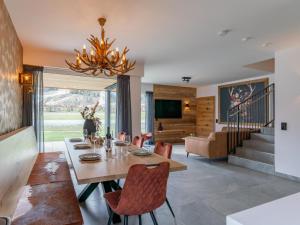 a dining room with a table and chairs and a chandelier at Bergzicht 2A in Sankt Lorenzen ob Murau