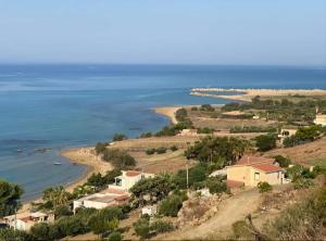 an aerial view of a beach with houses and the ocean at La Foggia seaside paradise in Siculiana