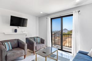 a living room with a couch and a large window at Morgan Residences 508 in Cabo San Lucas
