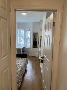 a hallway with a bed and a person in a mirror at Private Single Room with Shared Bathroom 536C in Toronto