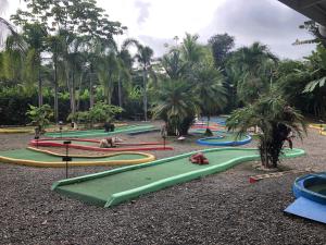 a group of slides in a park with palm trees at Casa Toucan mit privat Pool near NP Ballena in Uvita