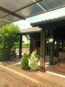 an outdoor patio with a pergola and two bushes at Apartments with a parking space Sveta Nedelja, Prigorje - 21835 in Strmec Samoborski