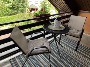a table and chairs on a balcony with a cup of coffee at Apartments with a parking space Sveta Nedelja, Prigorje - 21835 in Strmec Samoborski