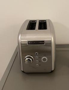 a toaster is sitting on the floor next to a wall at ApartmentInCopenhagen Apartment 1539 in Copenhagen