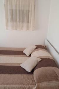 two beds sitting next to each other in a bedroom at Apartment Ostricka luka 11451b in Zaglavice