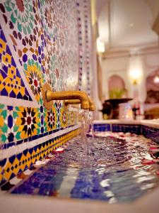 a bathroom with a sink with water coming out of it at Riad Al-Qurtubi in Tangier