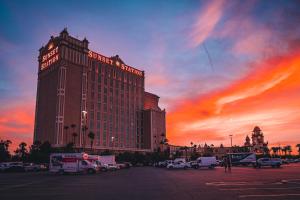 a large hotel building with a sunset in the background at Sunset Station Hotel & Casino in Las Vegas