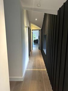 a hallway of a house with wooden floors and white walls at The Hayloft in Strabane