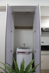 La cuisine est équipée d'un réfrigérateur et d'un évier. dans l'établissement Abreeza 1BR condo w/ balcony,wifi & Netflix, à Davao