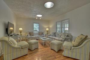 a living room with couches and chairs and a table at Mccaysville River House in McCaysville