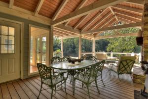 a screened in porch with a table and chairs at Mccaysville River House in McCaysville