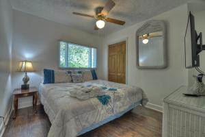 a bedroom with a bed and a ceiling fan at Mccaysville River House in McCaysville