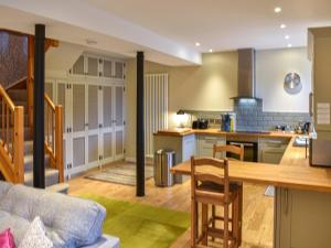 a kitchen with a couch and a table in a room at Barn End in Pooley Bridge